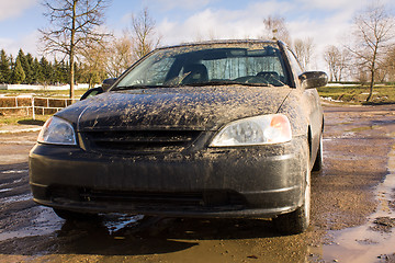 Image showing black car in mud.