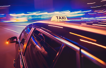 Image showing Taxi taking a left turn at night
