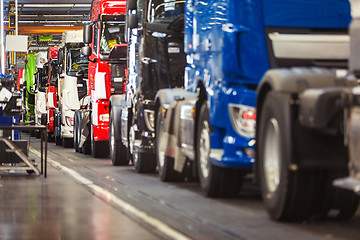 Image showing Row of trucks in a production hall