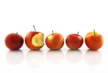 Image showing One half-bitten apple among the whole ones