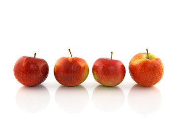 Image showing Four red apples in a row