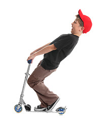 Image showing Child plays on a scooter