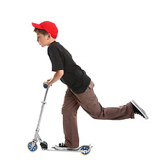 Image showing Child riding a scooter toy