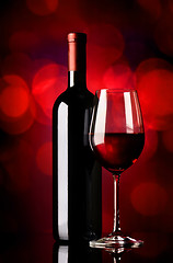 Image showing Bottle with wine on red