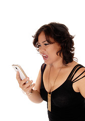 Image showing Young woman shouting at her cell phone.