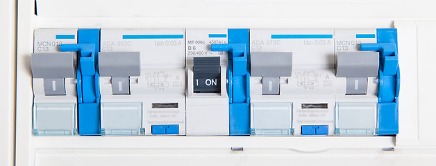 Image showing Old german fusebox, with blue buttons