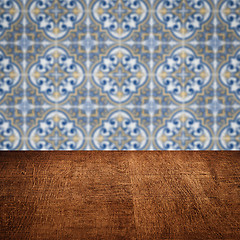 Image showing Wood table top and blur vintage ceramic tile pattern wall