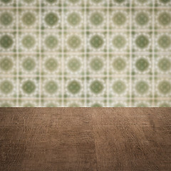 Image showing Wood table top and blur vintage ceramic tile pattern wall