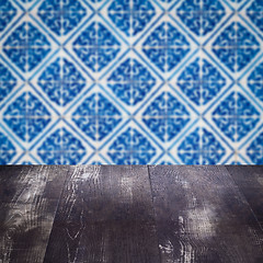 Image showing Wood table top and blur vintage ceramic tile pattern wall