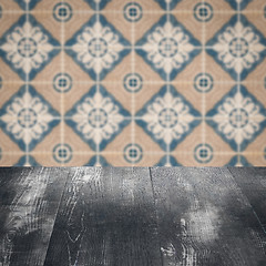 Image showing Wood table top and blur vintage ceramic tile pattern wall