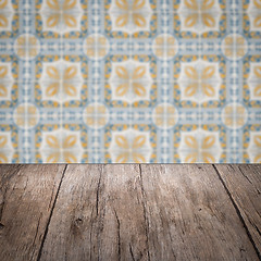 Image showing Wood table top and blur vintage ceramic tile pattern wall