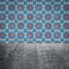 Image showing Wood table top and blur vintage ceramic tile pattern wall