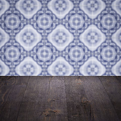 Image showing Wood table top and blur vintage ceramic tile pattern wall