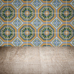 Image showing Wood table top and blur vintage ceramic tile pattern wall