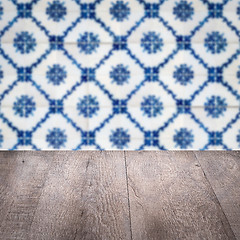 Image showing Wood table top and blur vintage ceramic tile pattern wall