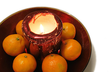 Image showing oranges around a christmas candle decoration