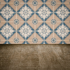 Image showing Wood table top and blur vintage ceramic tile pattern wall