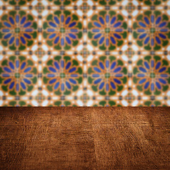 Image showing Wood table top and blur vintage ceramic tile pattern wall