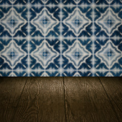 Image showing Wood table top and blur vintage ceramic tile pattern wall