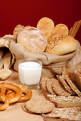 Image showing Assortment of baked breads and prezells with yoghurt