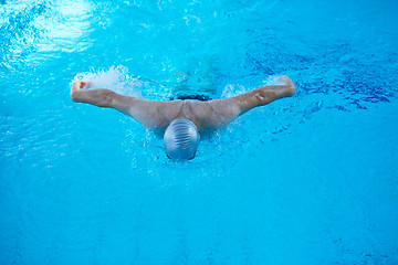 Image showing swimmer excercise on indoor swimming poo