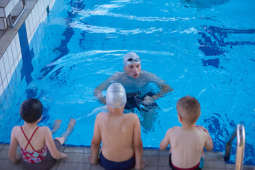 Image showing child group  at swimming pool school class