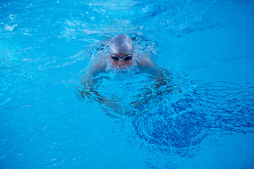 Image showing swimmer excercise on indoor swimming poo