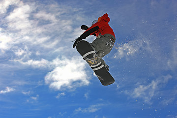 Image showing Snowboarder jumping high in the air