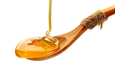 Image showing wooden spoon of honey