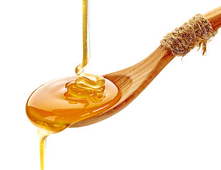 Image showing honey pouring into wooden spoon