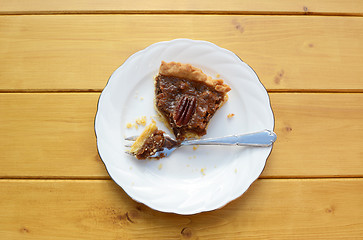 Image showing Half-eaten slice of pecan pie