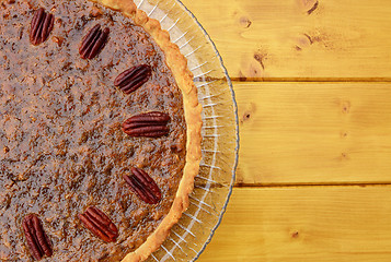 Image showing Half pecan pie served on a glass plate