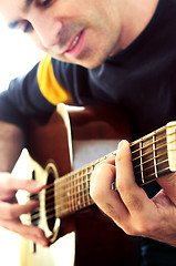 Image showing Man playing a guitar