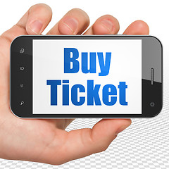 Image showing Vacation concept: Hand Holding Smartphone with Buy Ticket on display