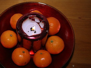 Image showing festive candle and clementines