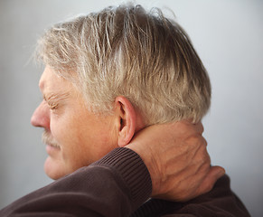 Image showing senior man with aching neck