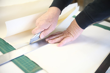 Image showing man cutting art paper