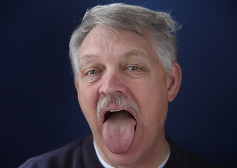 Image showing man showing his tongue  