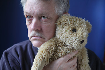 Image showing senior holding teddy bear	