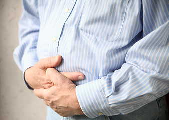 Image showing businessman with bad stomach pain