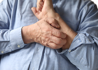 Image showing businessman with an itchy arm