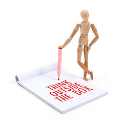 Image showing Wooden mannequin writing - Think outside the box