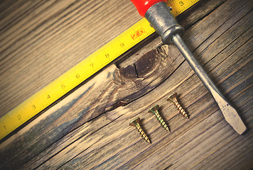 Image showing antique screwdriver, screws and measuring lenght 