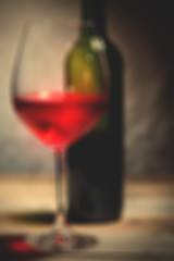 Image showing red wine in a glass and green bottle