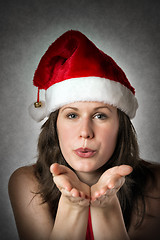 Image showing Portrait kissing Santa Woman