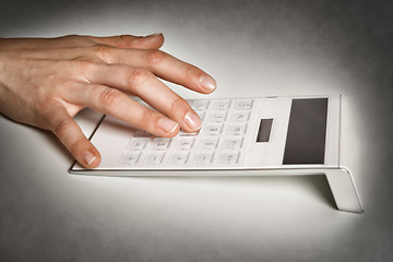 Image showing Female hand with calculator