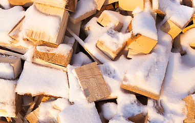 Image showing firewood under snow  