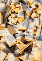 Image showing firewood under snow  