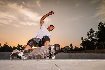 Image showing Skateboarder in a concrete pool 