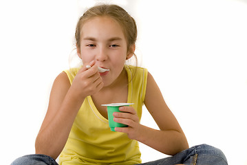 Image showing Girl eating yoghurt II